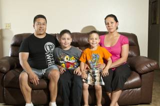 The Loya family, from left to right, Gonzalo, Jovy, Kenneth and Susana Reyes pose in their apartment, Thursday April 26, 2012. The Loyas participate in a support group at Nevada PEP for their son Jovy, who suffers from Asperger's syndrome.